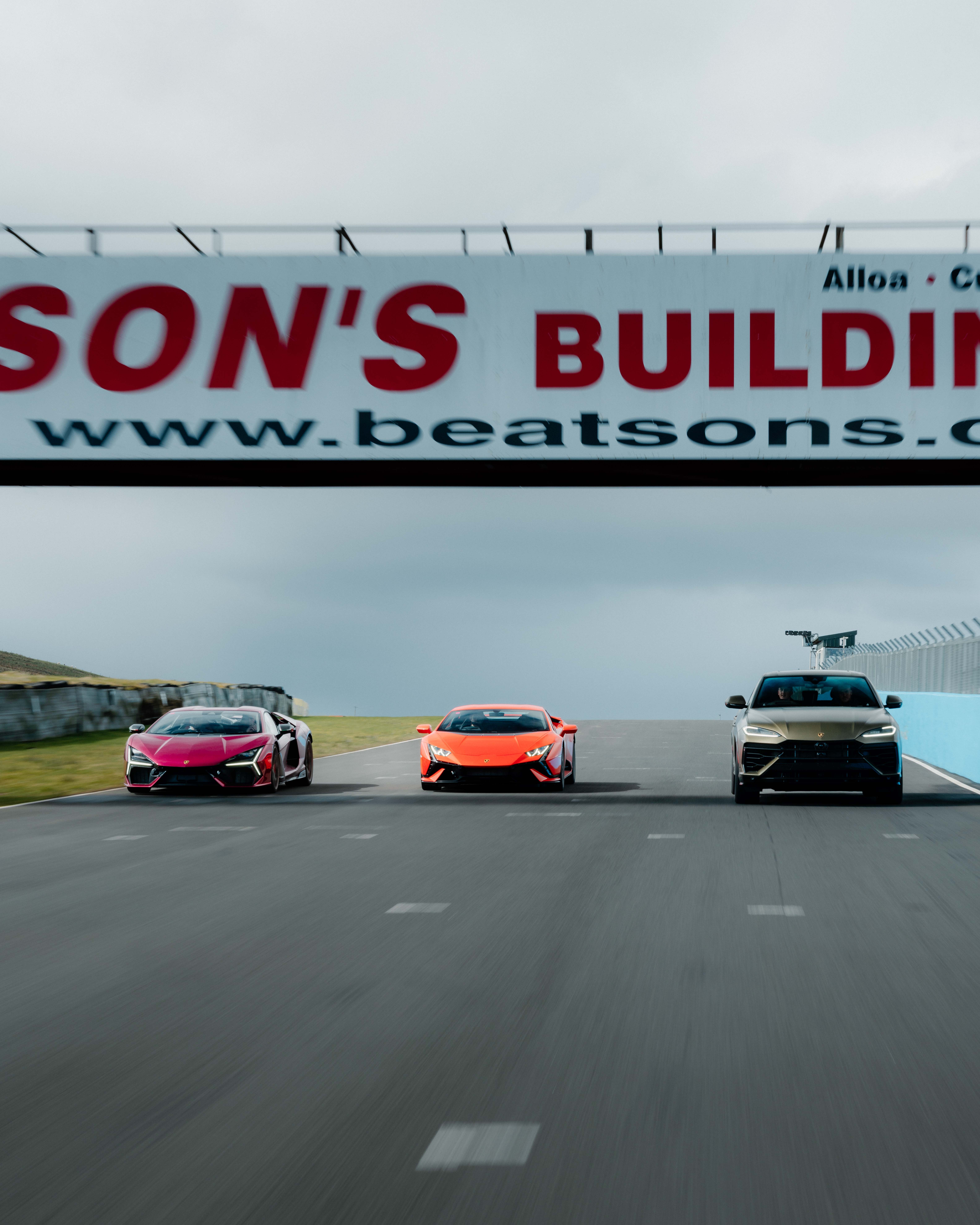 Three Lambourghinis on a racing track